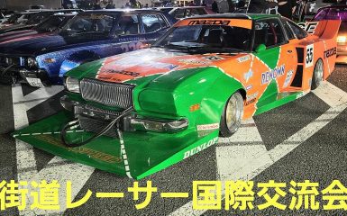 Colorful modified racing cars at a Street Racer International Exchange event in Japan, featuring a green Mazda.