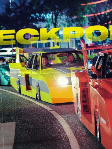Cars lined up during a night street race event, with neon CHECKPOINT sign overhead.