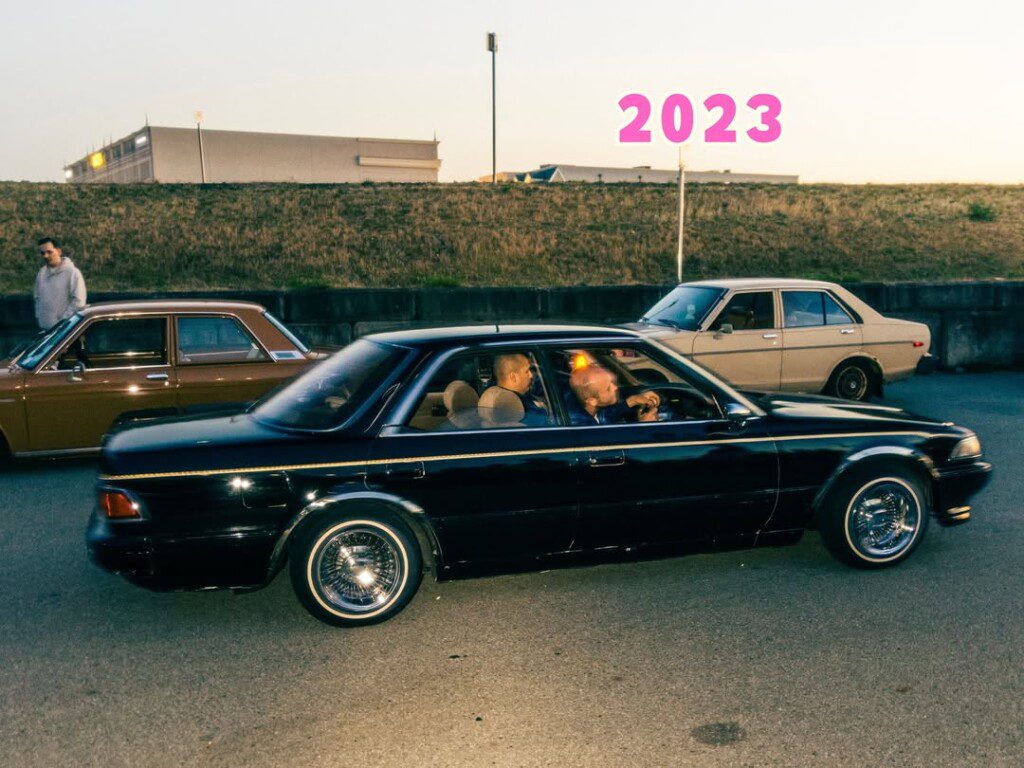 Vintage cars on display at an outdoor car event in 2023, showcasing classic styles and enthusiasts.